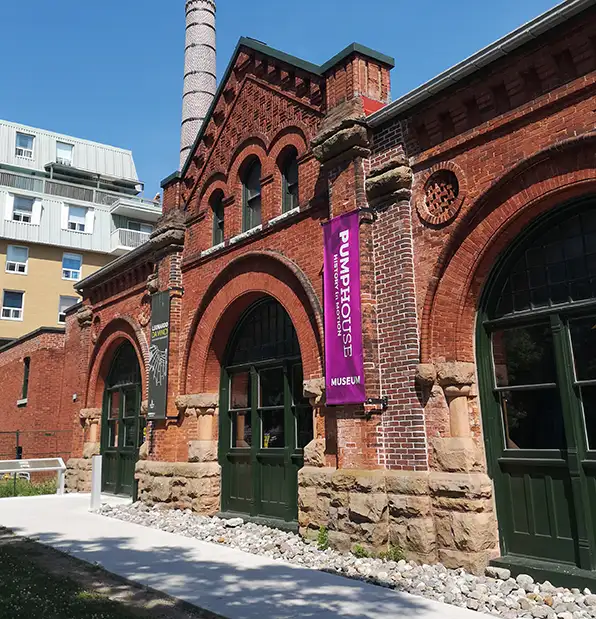 Kingston's PumpHouse museum, a historic pump house, built of red brick with green doors.